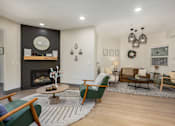 Thumbnail 8 of 20 - A living room with a fireplace and a green chair.