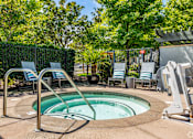 Thumbnail 2 of 20 - A small pool surrounded by chairs and trees.