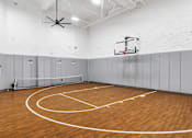 Thumbnail 3 of 4 - A basketball court with a wooden floor and a basketball hoop.
