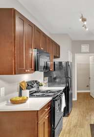 a kitchen with wooden cabinets and stainless steel appliances