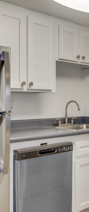 a washer and dryer are stacked on top of each other in a small laundry room