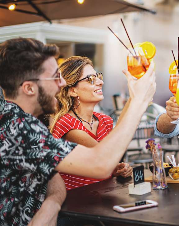 Four People Toasting with Drinks at Proto Apartments, Colorado
