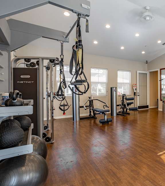 a home gym with exercise equipment and mirrors at Canyon Crest, Riverside, CA