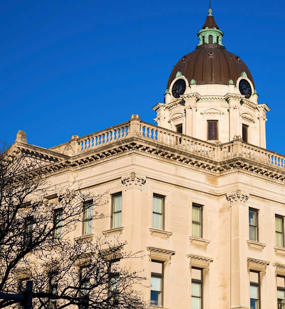 A large, stately building with a dome on top and columns on the front.
