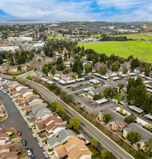 an aerial view of a suburban neighbourhood with cars parked on the street