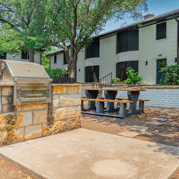 a grill in front of an apartment building