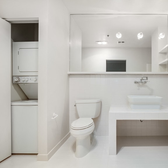 a bathroom with a toilet sink and a mirror