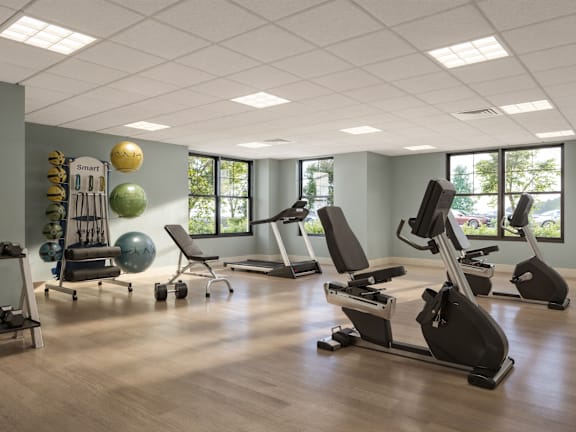 A gym with treadmills, exercise balls, and dumbbells. at Oskamp Flats Apartments, Cincinnati, OH