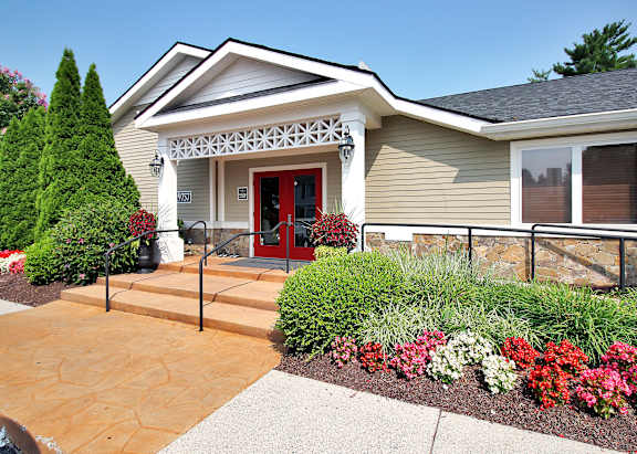 A house with a red door and a stone wall.