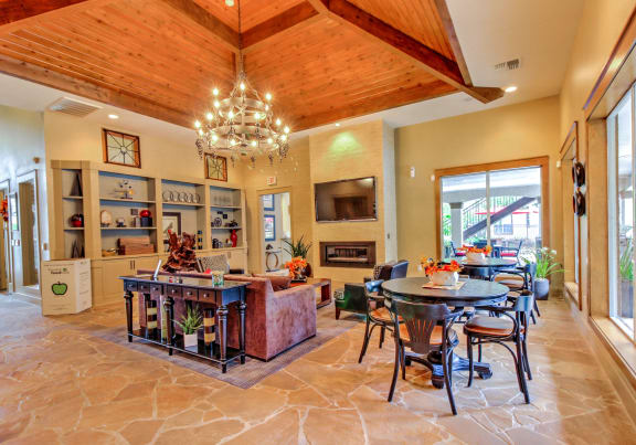 a dining room and living room with a table and chairs at Stone Creek at Old Farm Apartments, Houston, TX