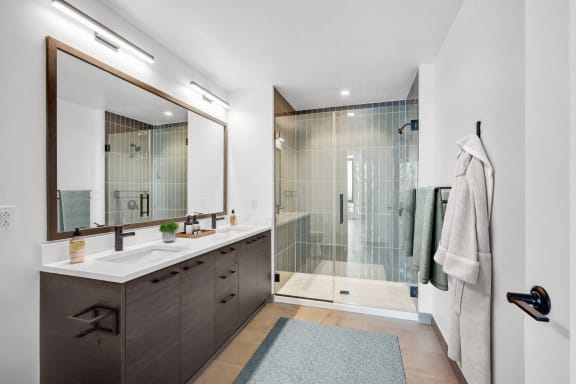 a bathroom with a shower and a sink and a mirror