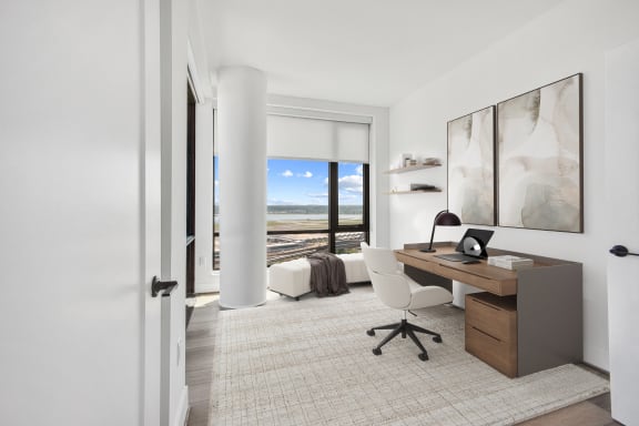 a home office with a desk and a view of the ocean
