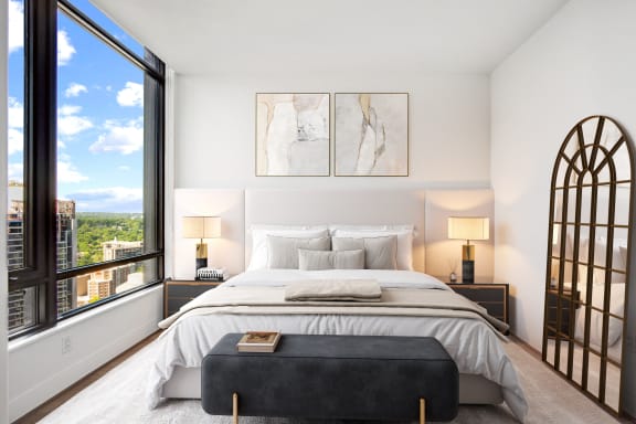 a bedroom with a bed and a large window