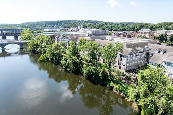 A river flows through a city with a bridge crossing over it.