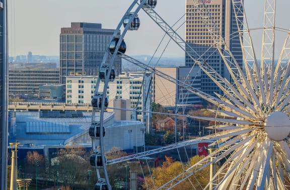 a cityscape with a ferris wheel in the foreground at Crogman School Lofts in GA 30315