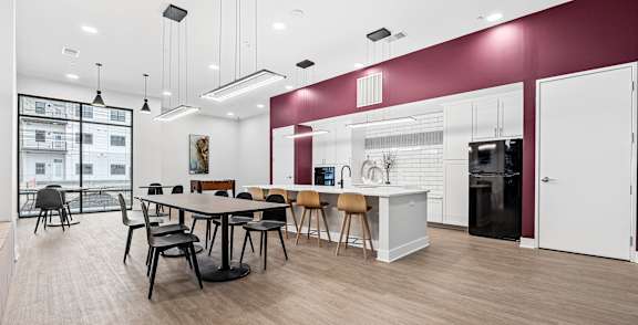 A modern kitchen with a dining table and chairs.