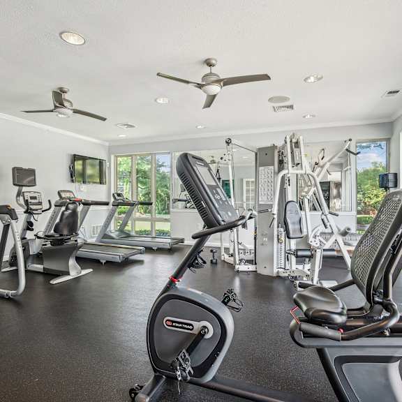 A spacious home gym with a variety of exercise equipment.