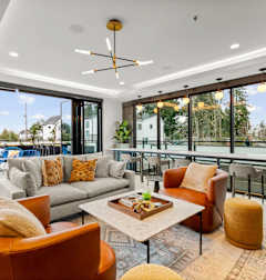 A modern living room with a large window and a view of the outdoors at Two 10 by Vintage, Shoreline, WA