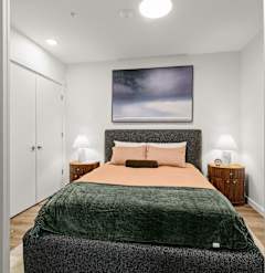 A living room with a beige couch, a chair, a coffee table, and a ceiling fan at Two 10 by Vintage, Shoreline, WA