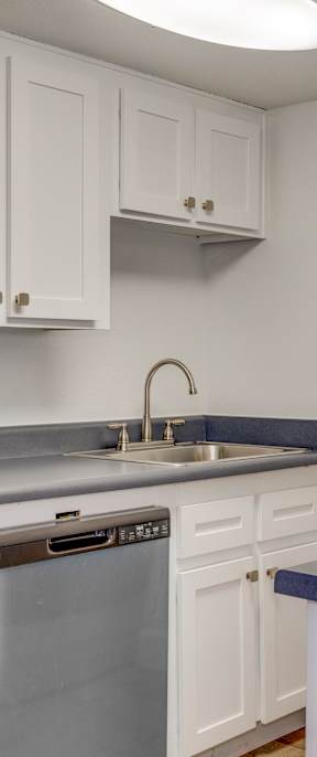 a washer and dryer are stacked on top of each other in a small laundry room