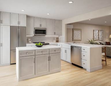 A modern kitchen with a refrigerator, microwave, oven, and sink.