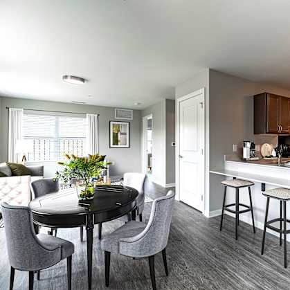 A modern kitchen with a dining table and chairs.