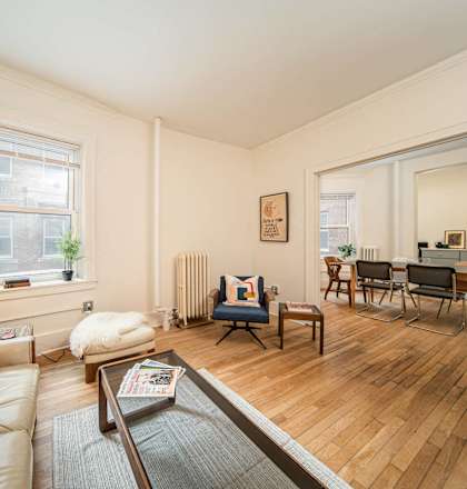 a living room with a couch and a table and a window