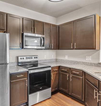 a kitchen with stainless steel appliances and granite counter tops