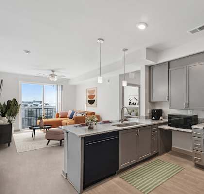 a kitchen with an island and a living room with a couch