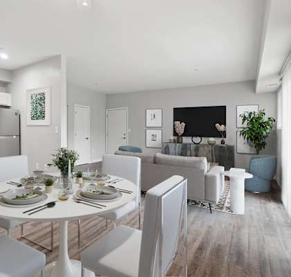 A modern kitchen with a dining table set for four.