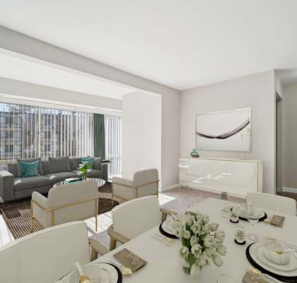 A dining room with a table set for a meal.