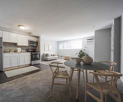 A modern kitchen with a dining table set for two.