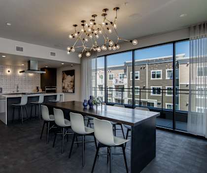 a kitchen and dining room with a large table and chairs
