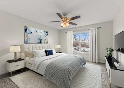 a bedroom with a bed and a ceiling fan