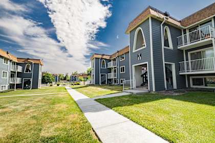 A sunny day at a residential complex with a clear blue sky.
