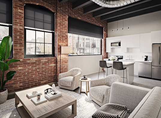 A modern living room with a brick wall and a grey sofa.