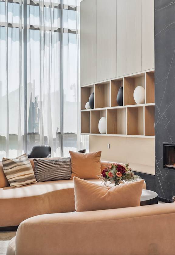 a living room with leather furniture and a fireplace