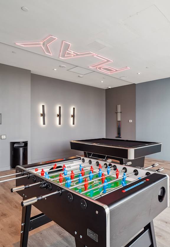 a game room with a foosball table and a pool table