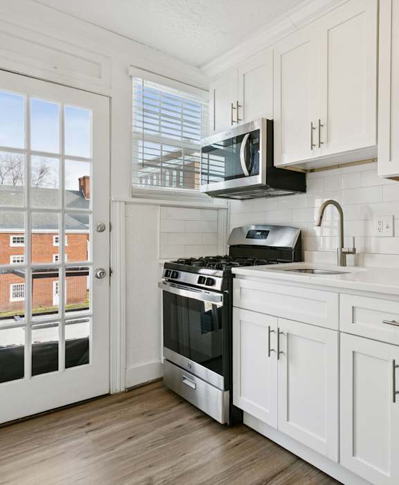 A kitchen with white cabinets and a stainless steel refrigerator. at Shipyard Shores Apartments, Newport News, 23607