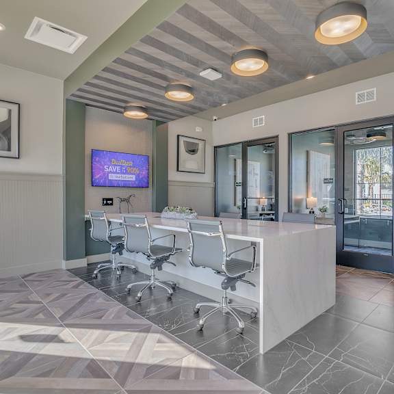 a conference room with a desk and chairs and a tv at Canter, Ocala, FL, 34474