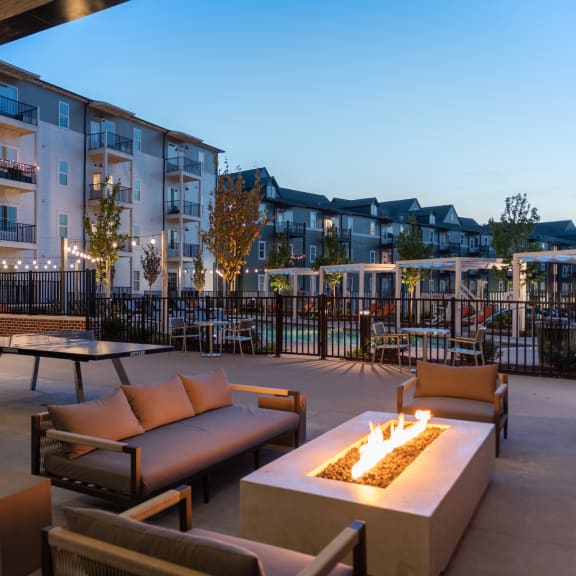 a patio with couches and tables and a fire pit at Livingston Flats Apartments, Chesterfield, VA, 23832