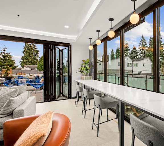 A modern living room with a long white table and chairsat Two 10 by Vintage, Shoreline, WA 98133