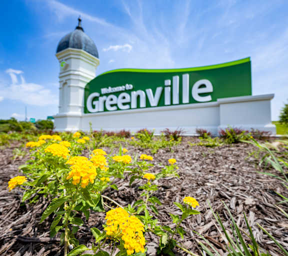 A sign that says Greenville in front of a white dome at Spring Lake Apartments in Greenville, NC, 27835