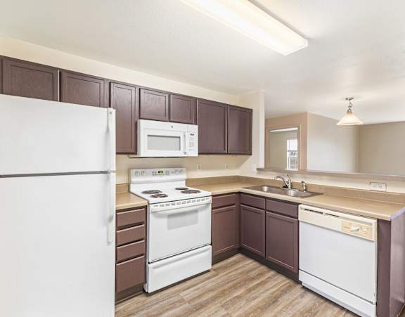 a kitchen with a stainless steel sink and white cabinets