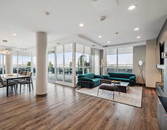a living room with a green couch and a dining room table