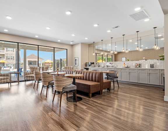 A modern living room with a kitchen in the background.