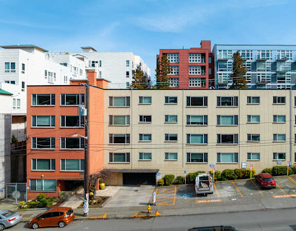 south facade of the building with parking lot in front of it