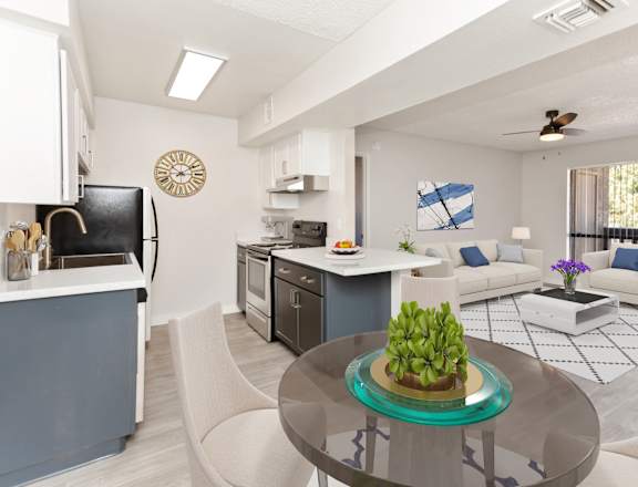 A modern kitchen with a dining area and a living room.