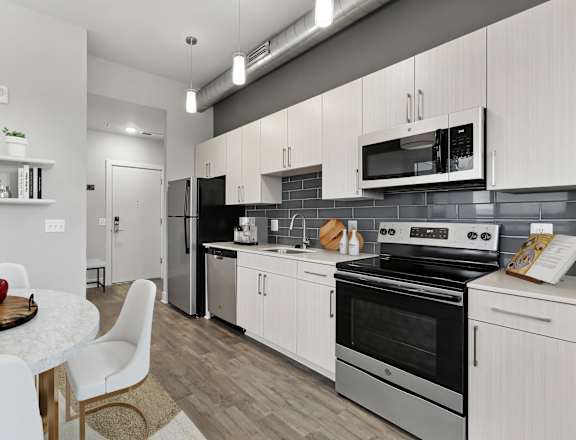 Modern Kitchens with Quartz and Stainless Finishes at The Oxford Apartments, Oxon Hill, MD