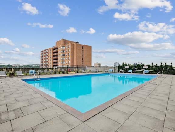 a swimming pool with a building in the background